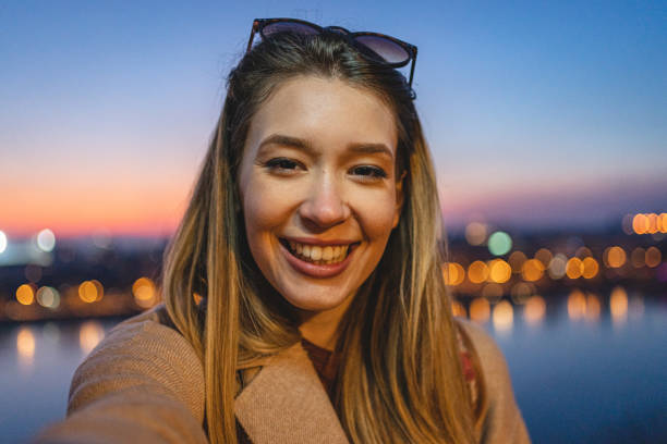 istock Woman is taking selfie at sunset 1220827016