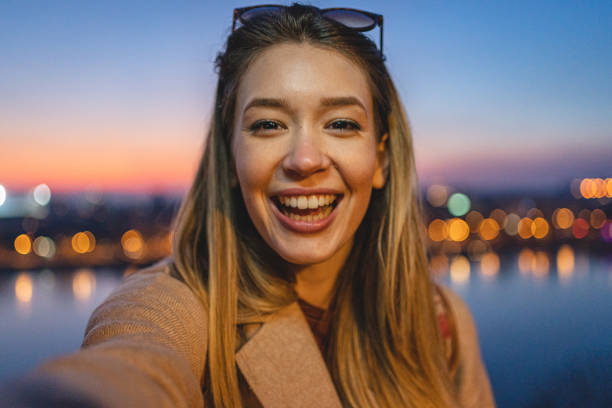 istock Woman is taking selfie at sunset 1220827089
