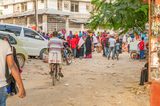 Large crowd of pedestrians and customers at a street market,  Zanzibar,  Tanzania