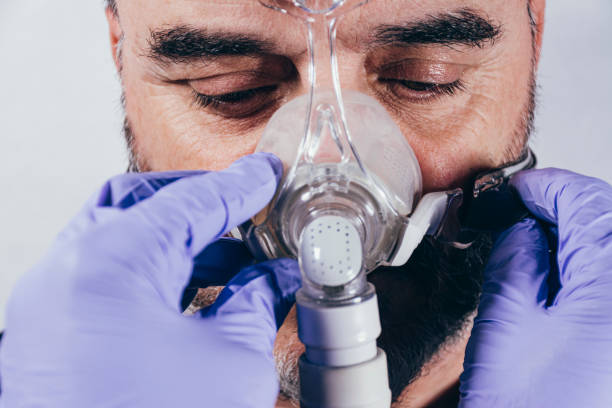 istock Man with respiratory mask for assisted breathing 1220827305