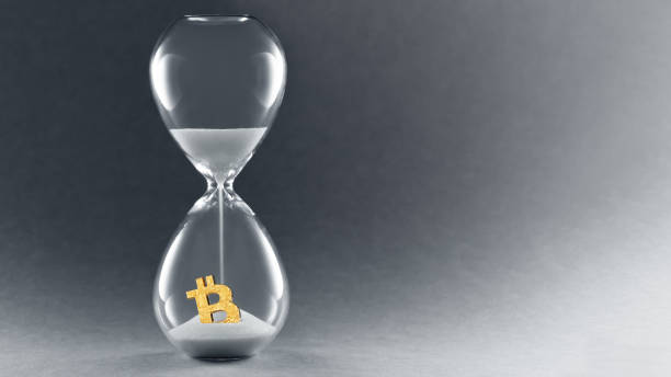 istock Hourglass on dark background. Concept passing cryptocurrency time. End of Bitcoin currency. Copy space 1220827334