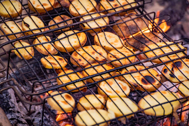 Cooking potatoes with lard on a fire