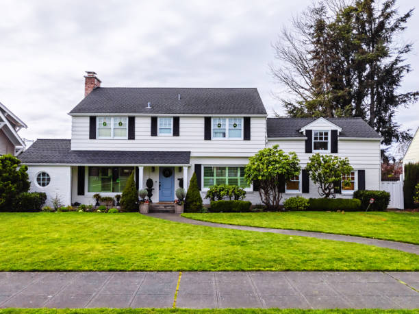 White American Colonial Style House Exterior Photo of a white American colonial style home exterior on a bright overcast spring day suburb stock pictures, royalty-free photos & images