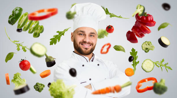 istock Healthy meal plan. Master chef and floating vegetables on grey background, creative collage 1220829222