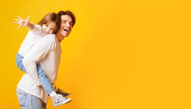 istock Positive dad holding his happy daughter on his back 1220829667