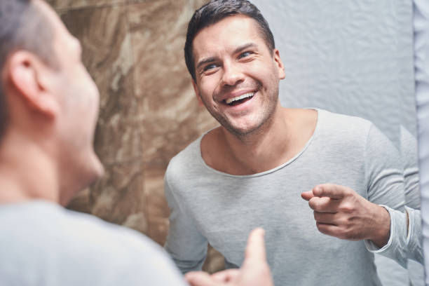 istock Dark-haired joyous male standing in a bathroom 1220830506