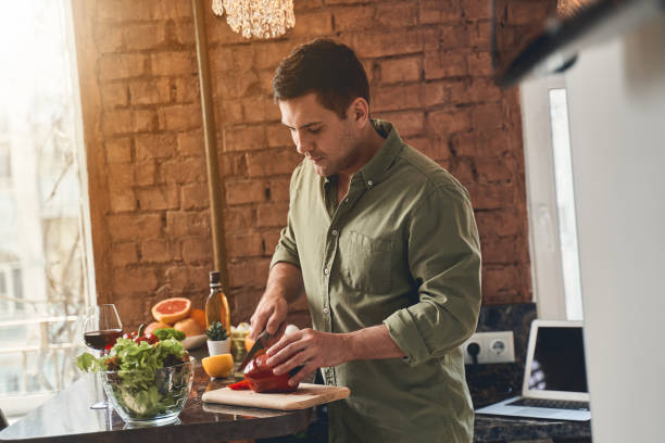 istock Man chopping vegetables on a wooden board 1220830676