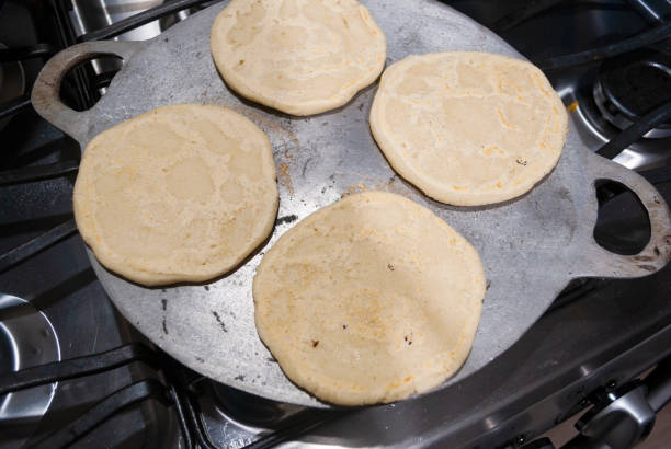 istock Nutritious handmade corn tortilla cooked on a metal griddle on a gas stove in a Guatemalan home. 1220830768