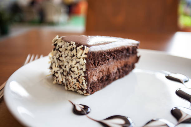 istock chocolate cake in the white plate is on the wood table 1220831332