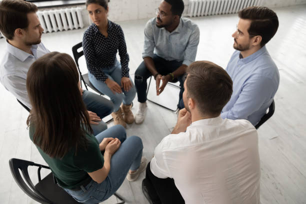 istock Multiethnic young people sit in circle participate in counseling therapy 1220833374