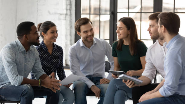 istock Smiling multiracial colleagues engaged in teambuilding in office 1220833394