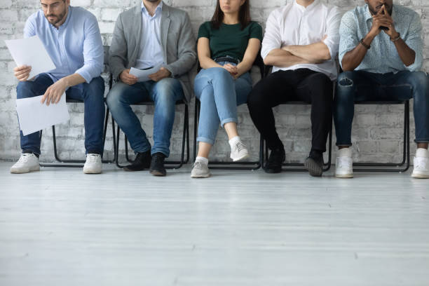 istock Stressed multiracial diverse candidates sit in row waiting 1220833399