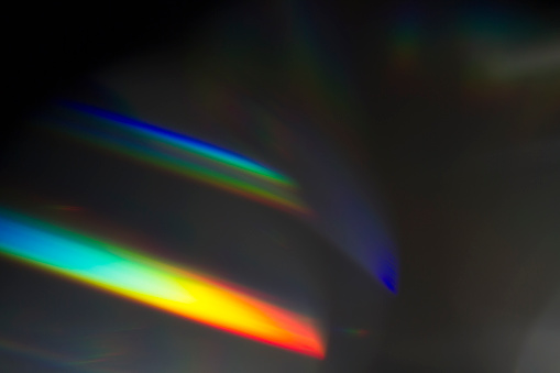 Sun reflection over a piece of crystal for a colorful lens flare on black background