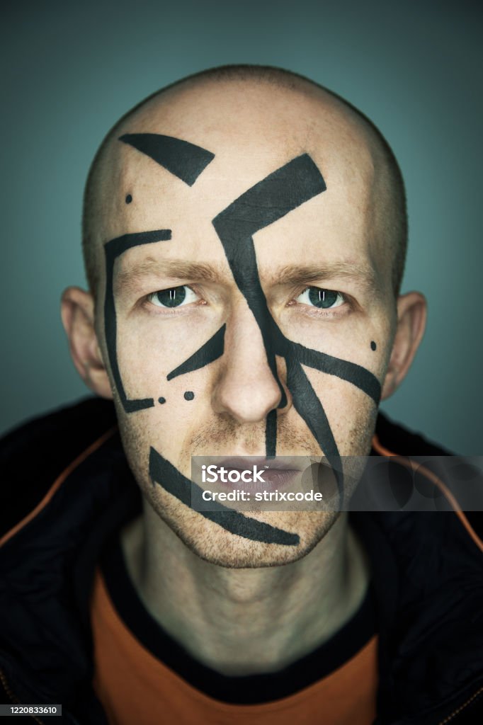 Close up portrait of man hiding his face from camera recognition with special camouflage makeup. Digital privacy in big city concept image. Achievement Stock Photo