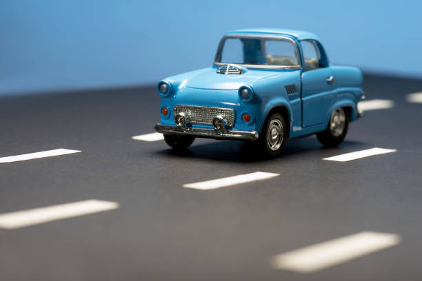 istock Blue toy car on an asphalt road. 1220834494