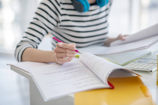 istock Woman in a striped shirt working with papers 1220834640