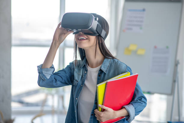 istock Dark-haired girl wearing vr headset and looking excited 1220834713