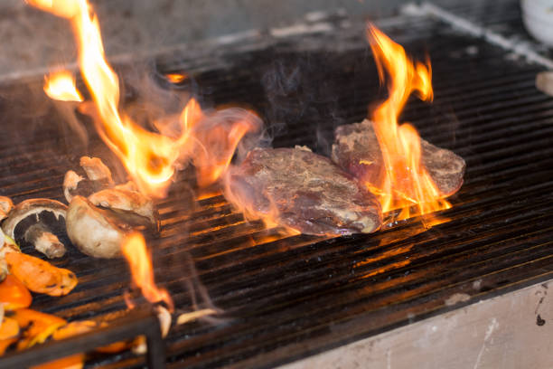 istock Frying steak with fire on the grill 1220835883
