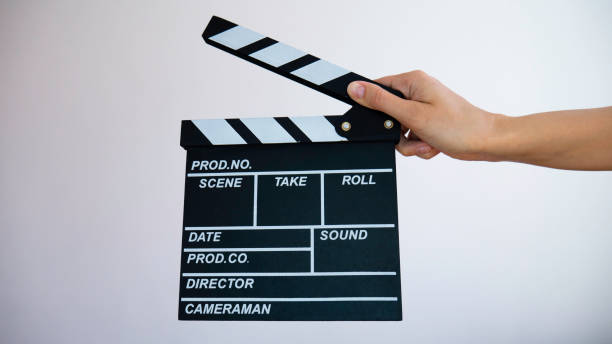 istock Empty wooden clapperboard in women's hands. Negative space for advertising. 1220835893