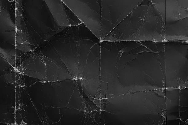 istock Wrinkled black old wrinkled paper. Dusty cardboard wrapping 1220837134