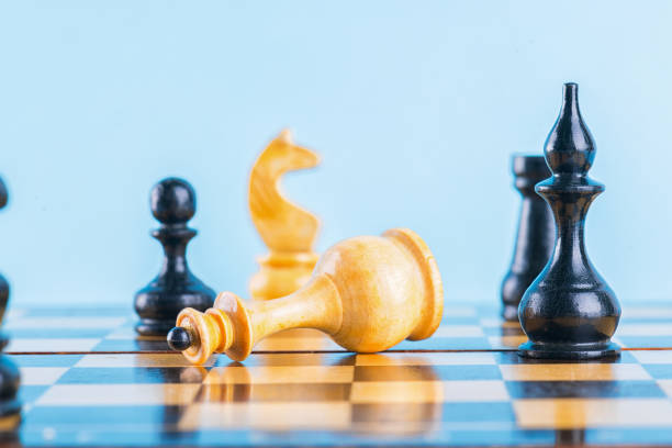 istock A bishop attack versus queen. Chess game on a blue background. Coronavirus Outbreak Global economic Recession. Small business owner affected by the coronavirus outbreak. 1220837638