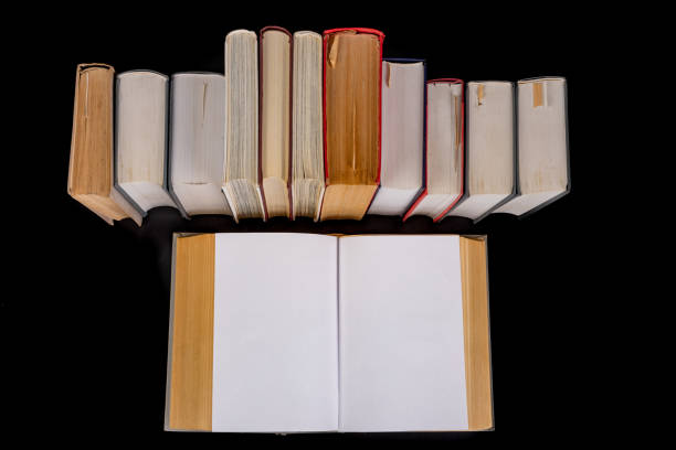 istock A stack of books on the desk. Old extensive literary publications. Dark background. 1220838793