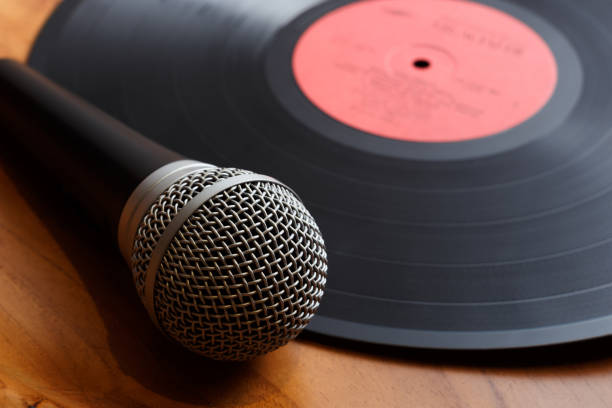 istock Vintage old vinyl record with microphone on a wooden background. 1220839710