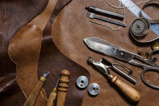 istock Crafting tools on natural cow leather in the tailoring workshop. 1220840698