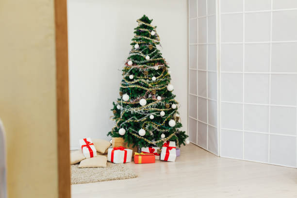 istock Christmas tree with gifts decor new year winter background 1220842101