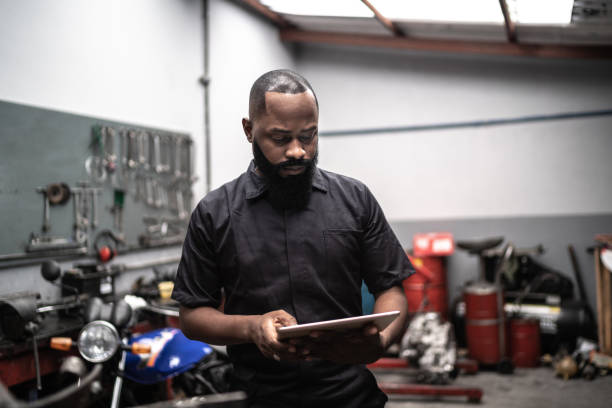 istock Man working with tablet in auto repair 1220842338