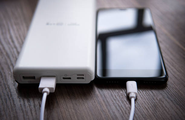 istock smartphone connected to the power bank 1220843451