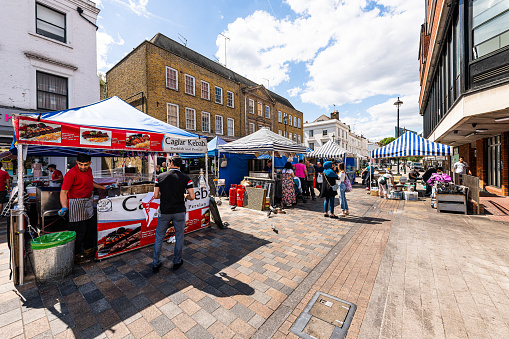 London, UK - June 21, 2018: Neighborhood of Pimlico in Victoria with Tachbrook street food market in downtown with stall stand vendors for fast food