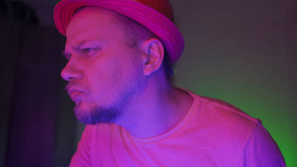 istock Serious Guy Works In Dark Room With Neon Glow 1220845883