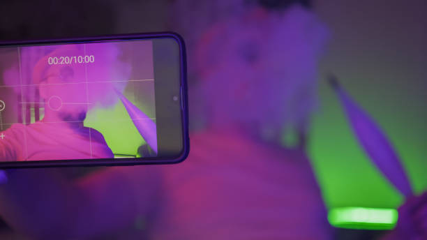 istock Man Takes Selfie Smoking Hookah In Neon Lights 1220846471