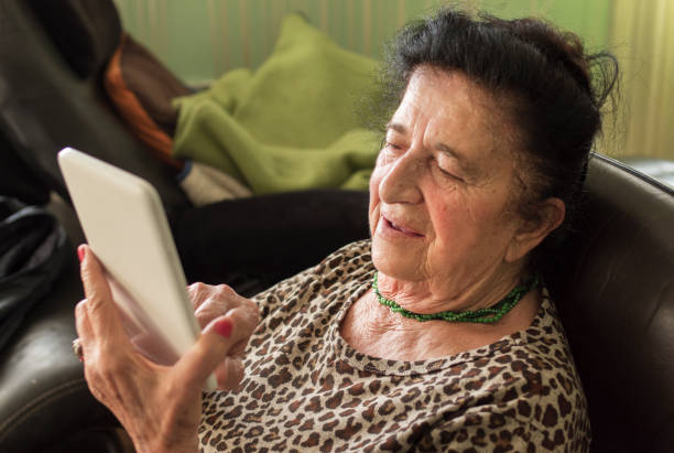 istock Senior woman video calling from home 1220847575