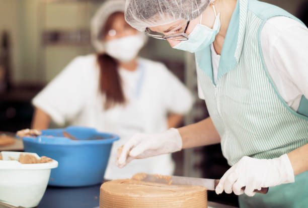 istock Essential workers with masks and gloves when working at catering service 1220847635