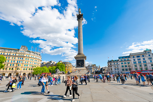 London, UK - June 21, 2018: Trafalgar square with Nelson column wide angle view and blue sky with many people outside on sunny summer day