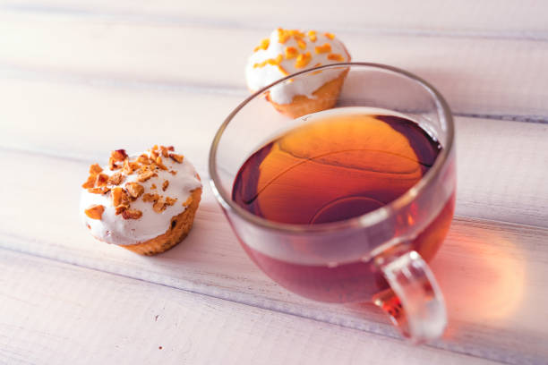 Dessert tea with Muffins on white wooden table. Close up.
