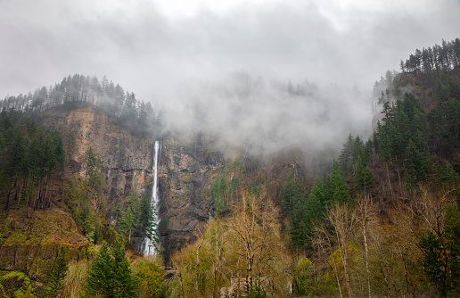 Multnomah Falls with low clouds. Columbia River Gorge, Oregon.
