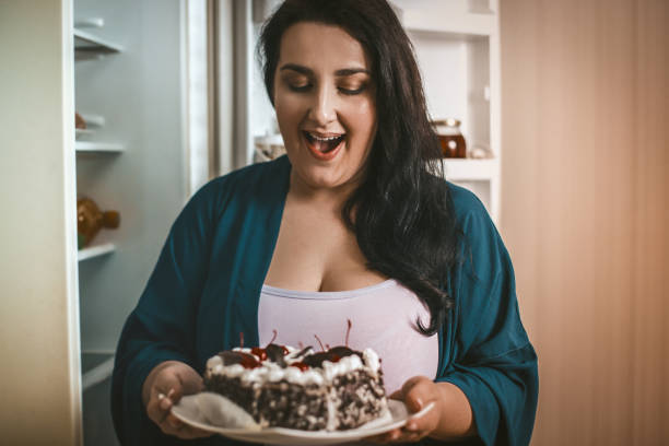 istock Plus Size Woman Admires Looking At Chocolate Dessert 1220849046