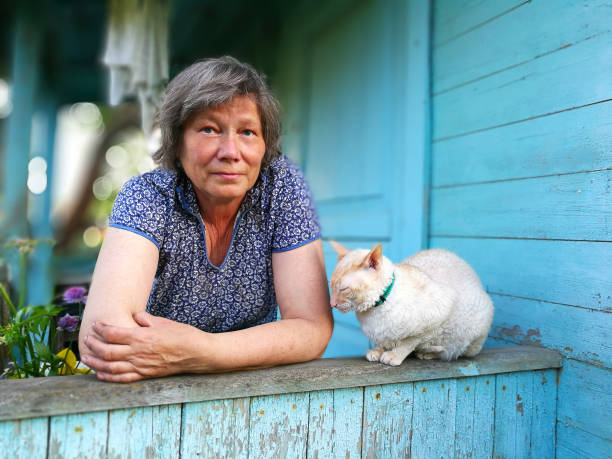 country woman with beautiful cat on  blue porch stock photo