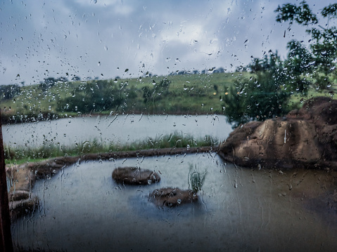 You can see the Rain Drops Against the Window as there is droplets with a big storm outside.