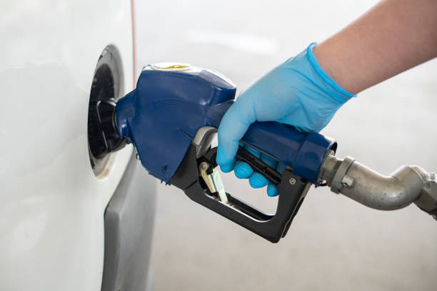 istock Pumping gasoline fuel in car. 1220851122