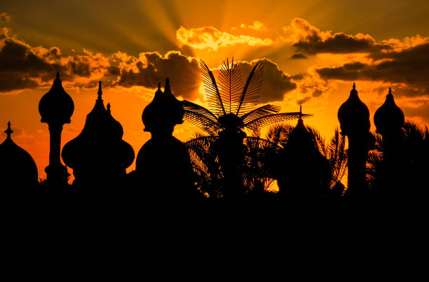 Dramatic and warm sunset behind romantic silhouettes of Arabic domes in Sharm el Sheikh Dramatic and warm sunset behind romantic silhouettes of Arabic domes in Sharm el Sheikh, Egypt, a popular tourist destination for Europeans in the winter months of the cold north. allah stock pictures, royalty-free photos & images