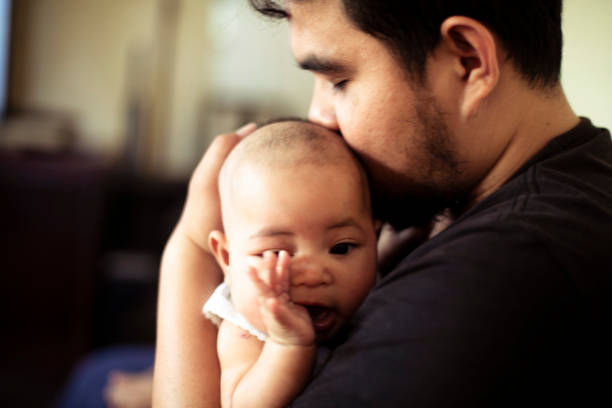 don't worry baby, I will stand by you... asian millennium father hug and kissing his cute baby men close up 20s asian ethnicity stock pictures, royalty-free photos & images