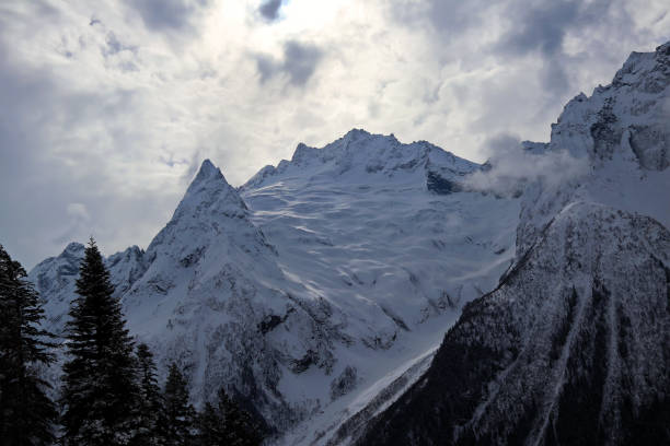 istock Snowy Mountains peaks in the clouds blue sky Caucasus 1220854548