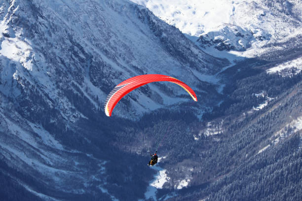 istock paraplane flying over snowy Caucasus mountains sunny blue sky 1220854750