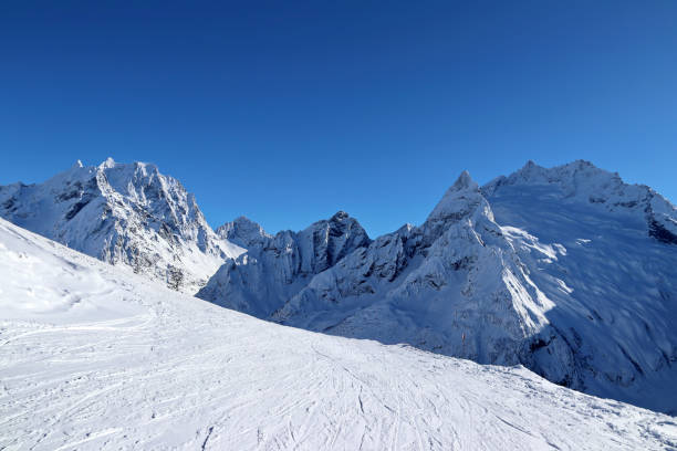 istock Snowy Mountains peaks and the blue sky Caucasus 1220854826