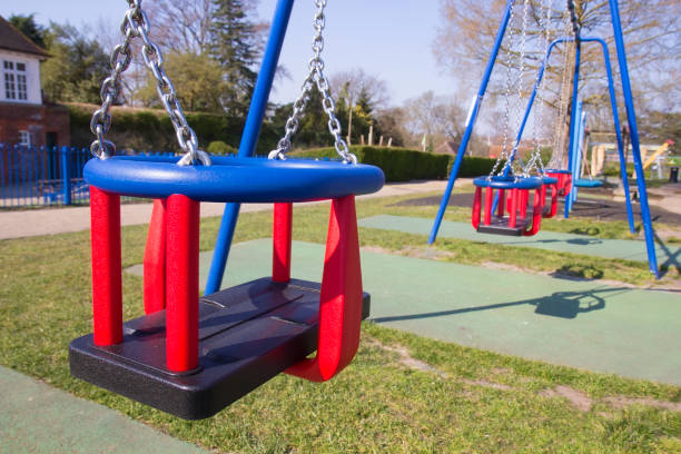 istock Empty swings in children's playground 1220856824