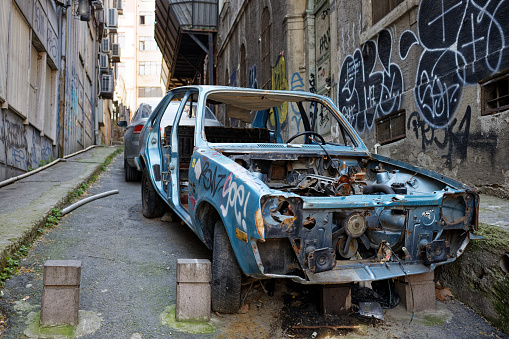 Kabatas, Istanbul / Turkey - April 13 2020: An abandoned junk car parked on the street, front view.
